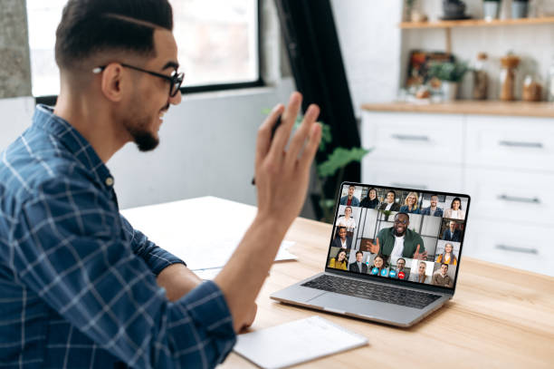 istock Group brainstorm, online video meeting, virtual conference with multiracial colleagues. Mixed race man communicate with business partners by video call uses laptop and app, work from home, greeting 1418582672