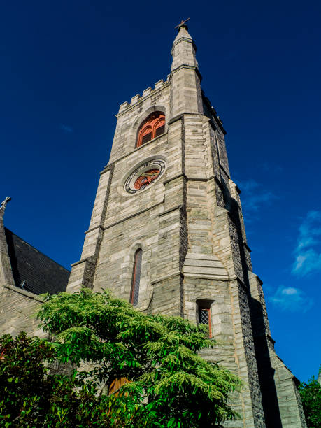 istock Church Tower Steeple with Green Tree in The Front 1418588236