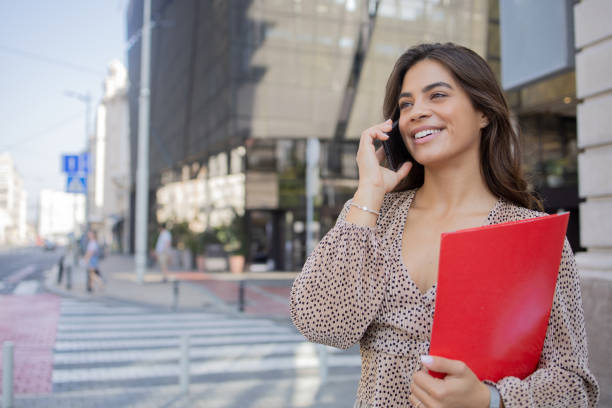 istock Happy young woman using phone 1418598759