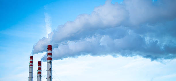 istock Air pollution. Smoking chimneys against blue sky. 1418602052