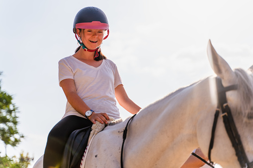 girl with down syndrome ridding   horse