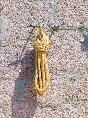 Rope hanging from the hook, wall