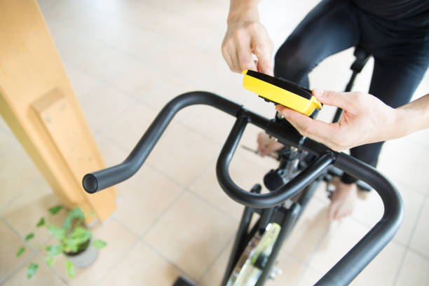man exercising with stationary bicycle in his room