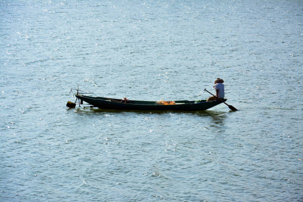 istock a fish man on the long boat on the sea 1418610530