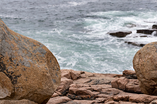 Peek through the granite rocks above the Atlantic Ocean waves below at Acadia National Park in Bar Harbor, Maine.