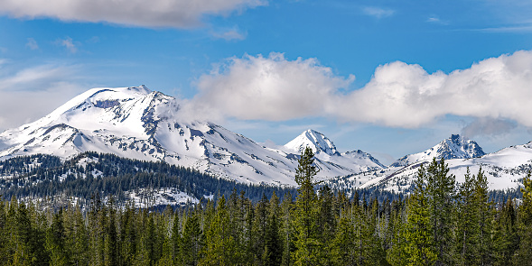 Vista view of Three Sisters mountains in Bend Oregon in the winter with snow on the peaks.