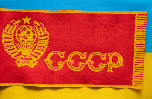 The flag of the USSR is red and the national flag of Ukraine is yellow-blue, back to the past for Russia, sanctions against the country, stop the war