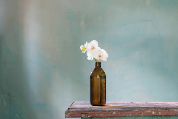 istock orchid flowers in bottle on dark background 1418656626