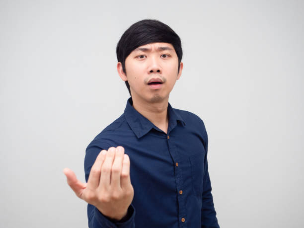 istock Asian man gesture beckon his hand say come on challenge concept portrait white background 1418657721