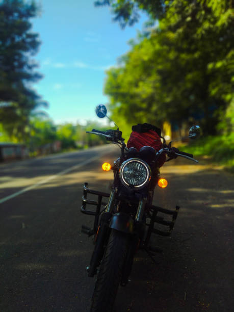 istock Cruiser motorbike standing in the empty road under tree shade 1418659438