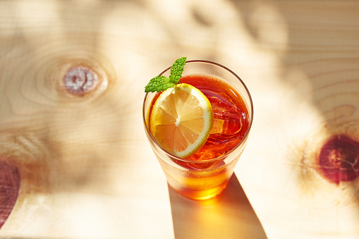 refreshing iced tea glasses on wooden background