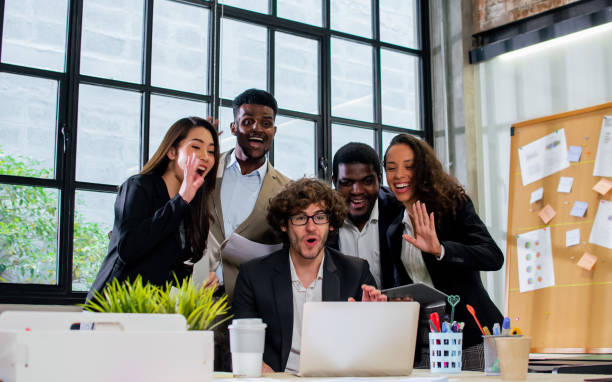 istock Diverse and multiracial smart businesspeople wearing formal suits, using computer, discussing by teleconference, brainstorming idea for company marketing plan in indoor modern office. 1418664249