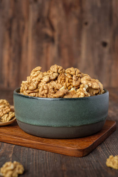 istock walnut in ceramic bowl on wooden tray in kiechen table 1418668489