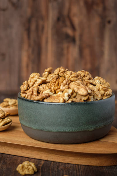 istock walnut in ceramic bowl on wooden tray in kiechen table 1418668496