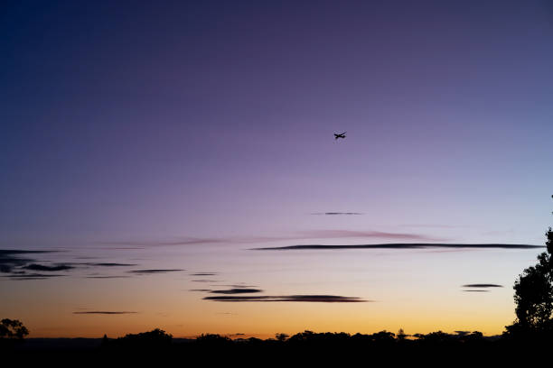 istock Airplane flying at the sunset 1418670567