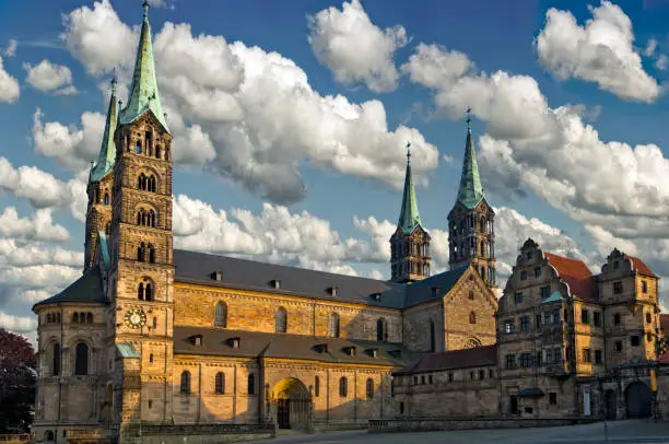 Bamberg Cathedral in the warm evening light of the sun with loosened clouds against a blue sky