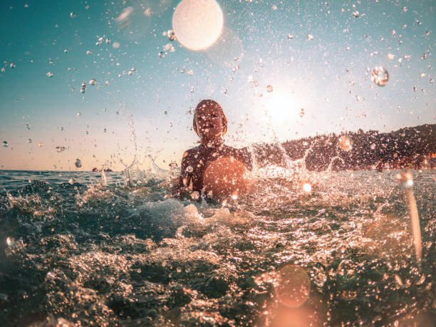 istock Happy Child Playing Inside the Water 1418682373