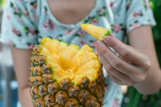 thailand woman cutting pineapple