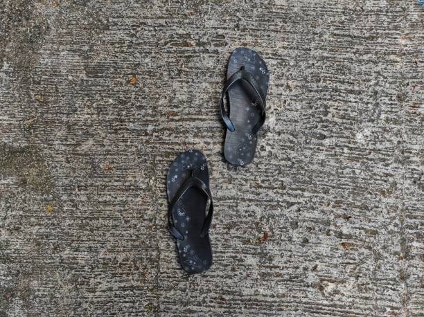 feet, sandals and pebbles