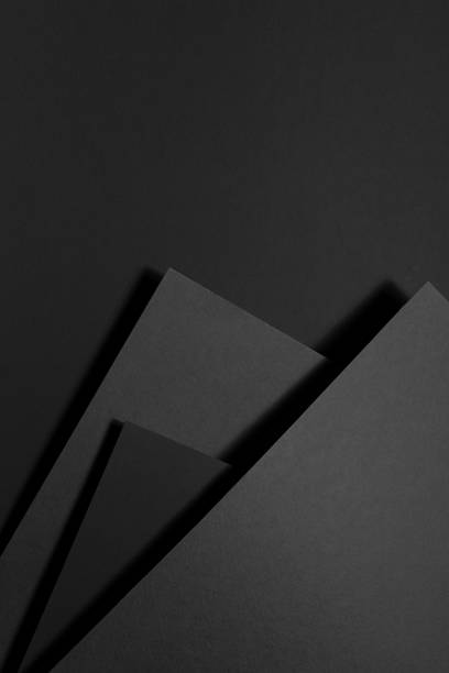 Dark grey carbon textured abstract geometric background with soar stepped rectangle surfaces, angles, black shadow lines in graphic minimal monochrome business style, top view, copy space, vertical. fondo geométrico abstracto texturizado de carbono gris oscuro con superficies rectangulares escalonadas elevadas, ángulos, líneas de sombra negras en estilo de negocio monocromático mínimo gráfico, vista superior, espacio de copia, vertical.