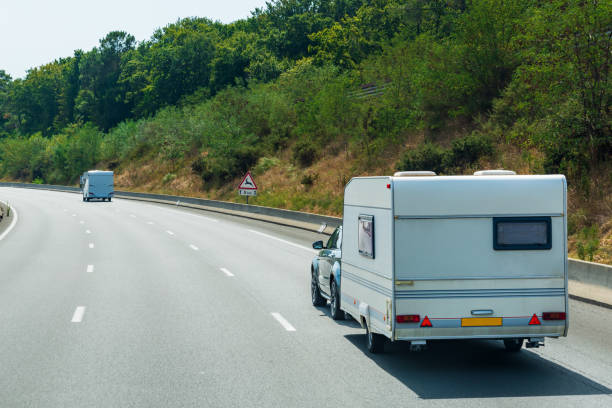 istock Motorhomes driving along a lonely highway lined with trees. 1418688881