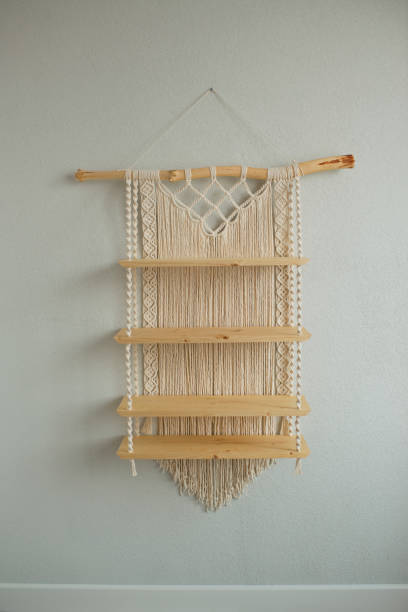 istock Macrame wooden shelf hanging on the wall 1418689808