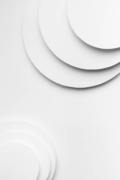istock White abstract geometric background in simple minimalist style with flying soft light white round surfaces as relievo stepped backdrop with copy space, top view, vertical. 1418690245