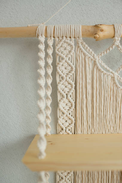 istock Macrame wooden shelf hanging on the wall 1418690297