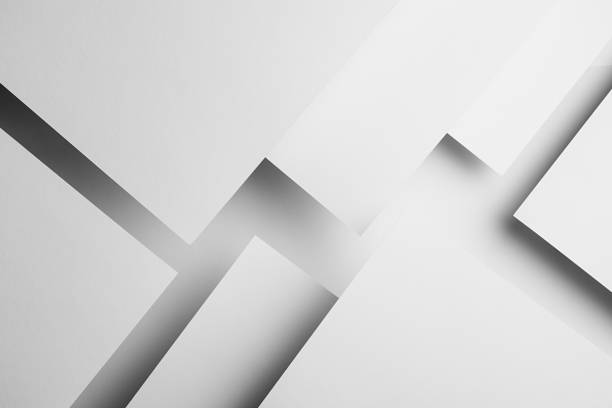 istock White abstract geometric background with white paper sheets soar as abstract surfaces in glow with triangles, corners, stripes, perspective, shadows in simple strict modern style for business. 1418690959