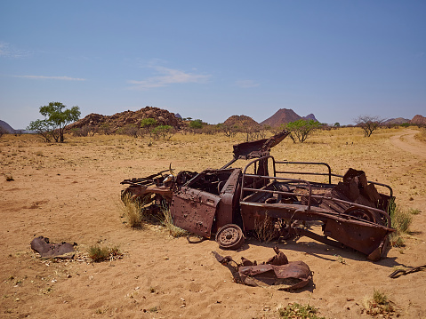 old car wreck standing in the desert of Kaokoland Namibia in Marienflusstal