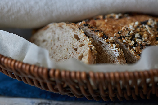 Rustic traditional spelled spelt bread close-up, copy space on white background in studio. Concept of traditional leavened bread baking methods and alternative healthy grains