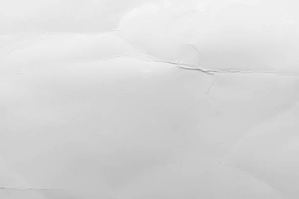istock Surface of the wrinkled white paper background 1418698738