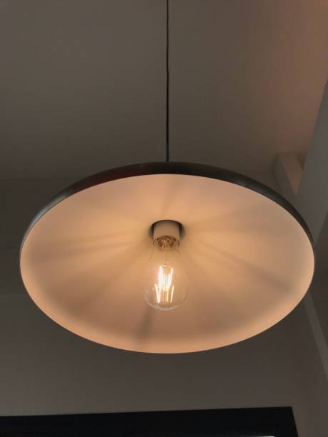 istock Hanging Lightbulb in the dark room 1418700072