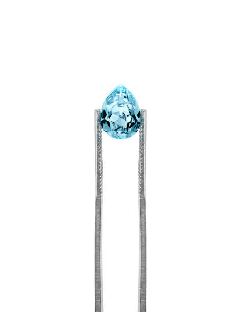 blue diamonds held in tweezers on a white background - sapphire blue diamond jewel imagens e fotografias de stock