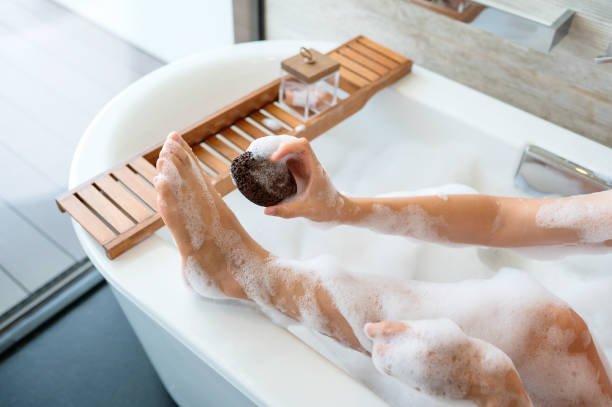 istock Woman using foot scrub pumice stone during a relaxing spa experience at home 1418717160