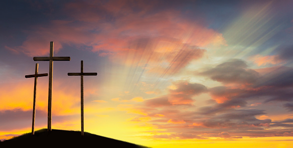 Crucifixion of Jesus Christ at dawn - three crosses on a hill