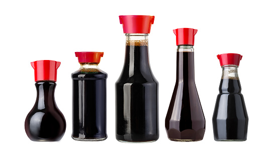 soy sauce bottles with red lids isolated on white background
