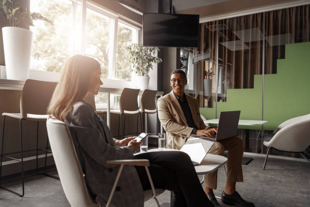 istock Smiling coworkers cooperating and working together at coworking space, teamwork concept 1418727079