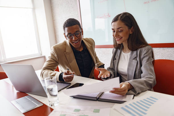 istock Smiling coworkers cooperating and working together at coworking space, teamwork concept 1418727080