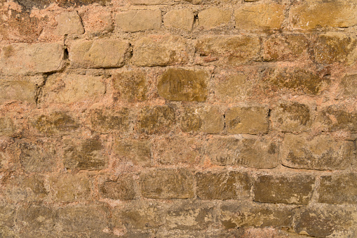 Closeup sandstone wall evenly bricked background