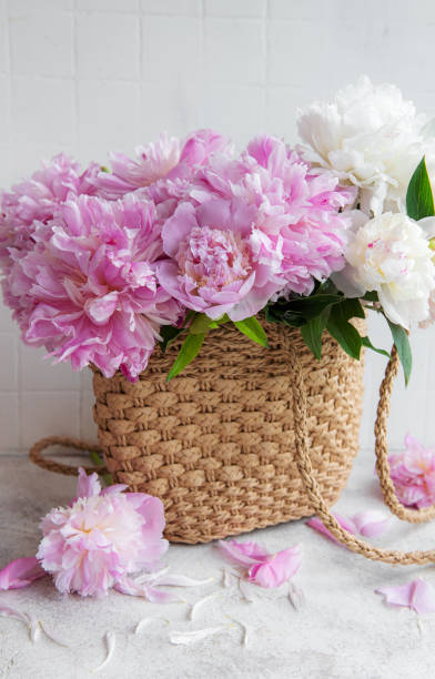 istock Wicker bag with peony flowers 1418731275