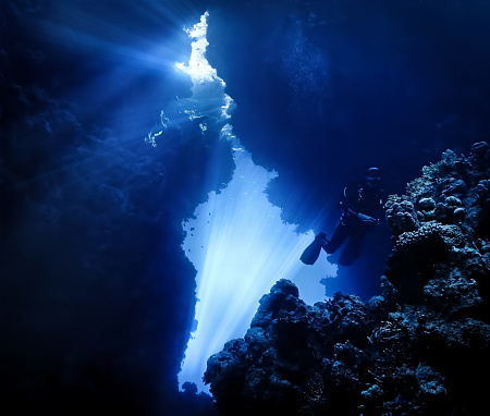 Artistic underwater photography from a scuba dive in caves with sunlight