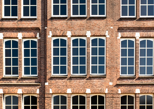 front view of an old Dutch palace with exposed brick and large windows