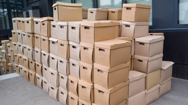 istock Pile of cardboard boxes on the ground. Stack of carton boxes for office documents. Moving office buisness. Relocation buisness. 1418741495
