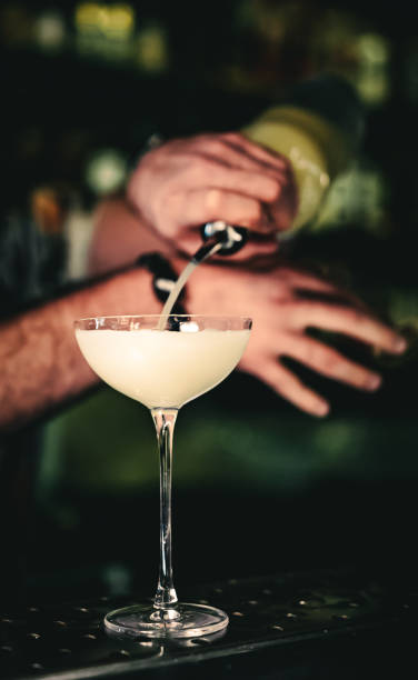istock man hand bartender making cocktail in glass on the bar counter 1418743974