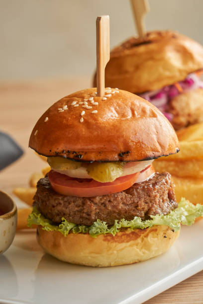 istock two beef burger with tomato, lettuce, cheese and juicy beef 1418751292