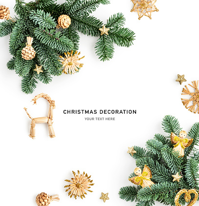 Fir tree branch with christmas decoration frame and creative layout. Golden angel, heart, snowflake and stars composition isolated on white background. Design element. Flat lay, top view