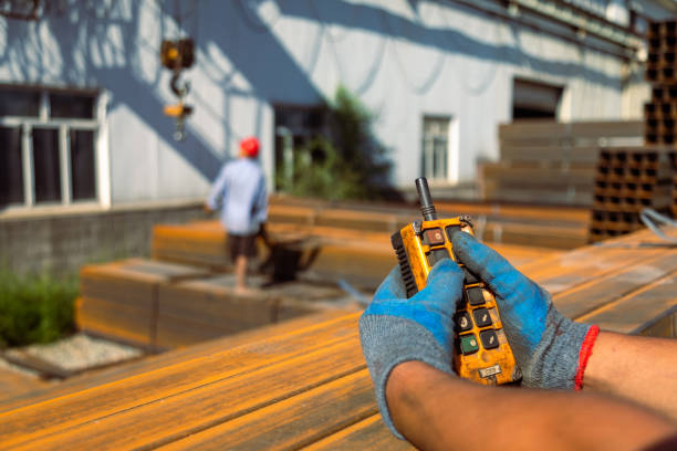istock Closeup of hands using remote control of gantry crane 1418757729