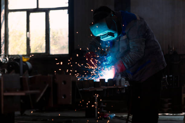 istock Industrial welder welding metal profiles 1418760465
