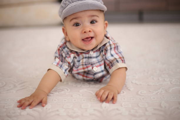 istock Portrait of a boy lying on the carpet. 1418761776
